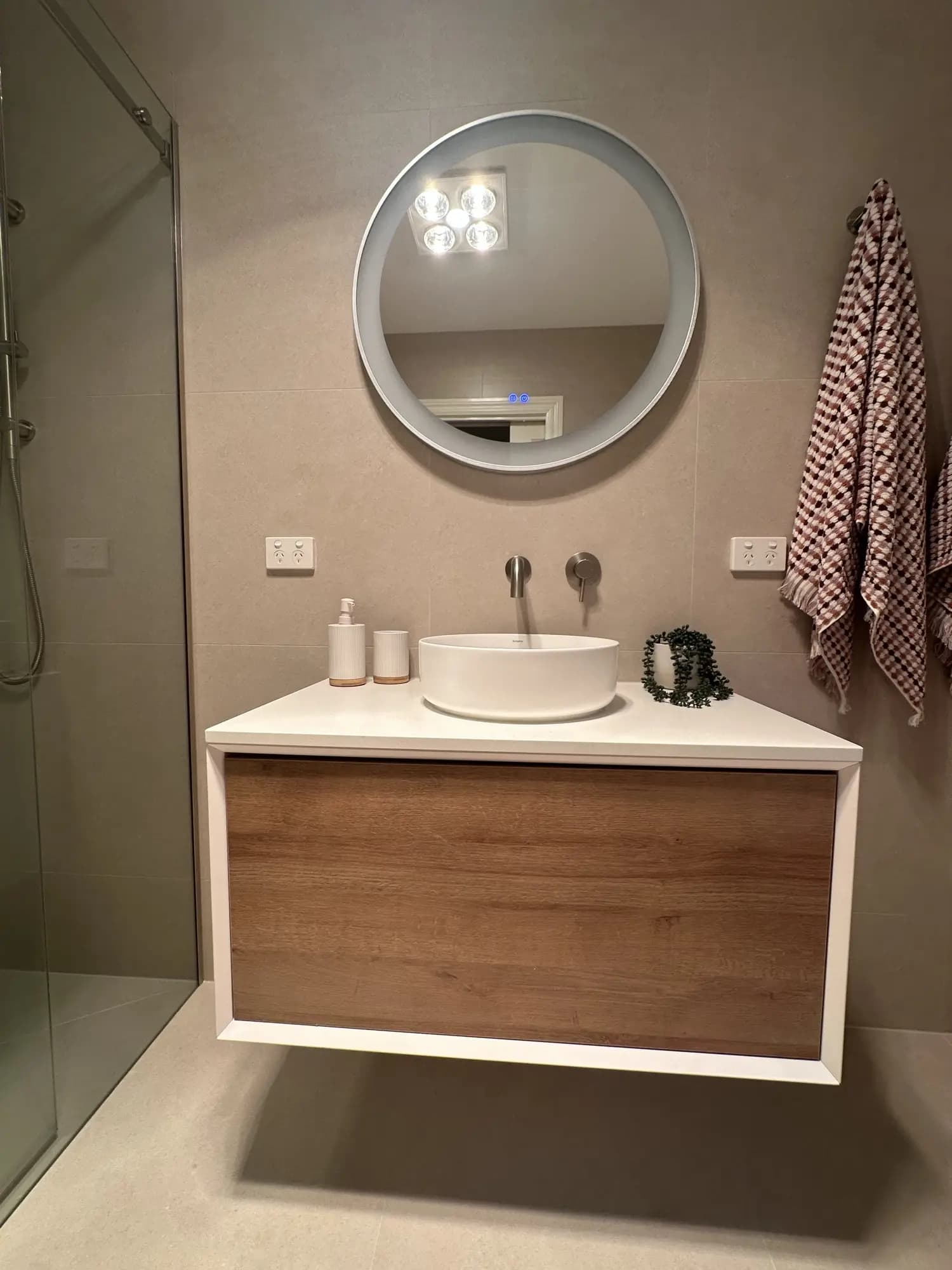 Complete bathroom renovation showing tiling and fixture installation